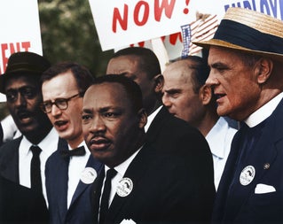 Martin Luther King standing with protesters.