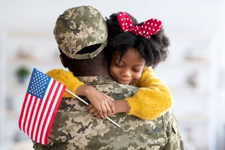 daughter hugging soldier