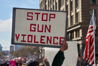 person holding "Stop Gun Violence" sign