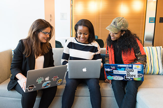 three women with laptops