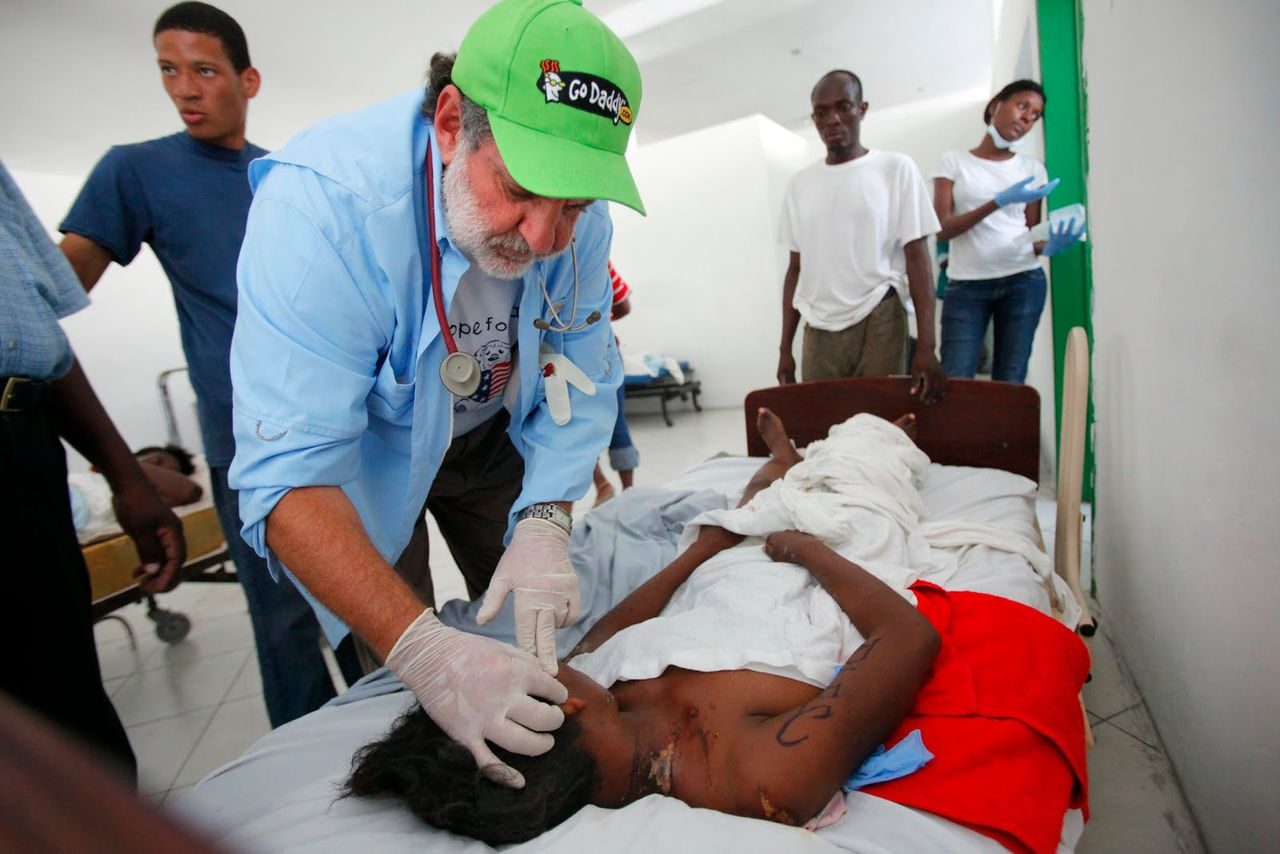 Bob Parson with injured Haitian person